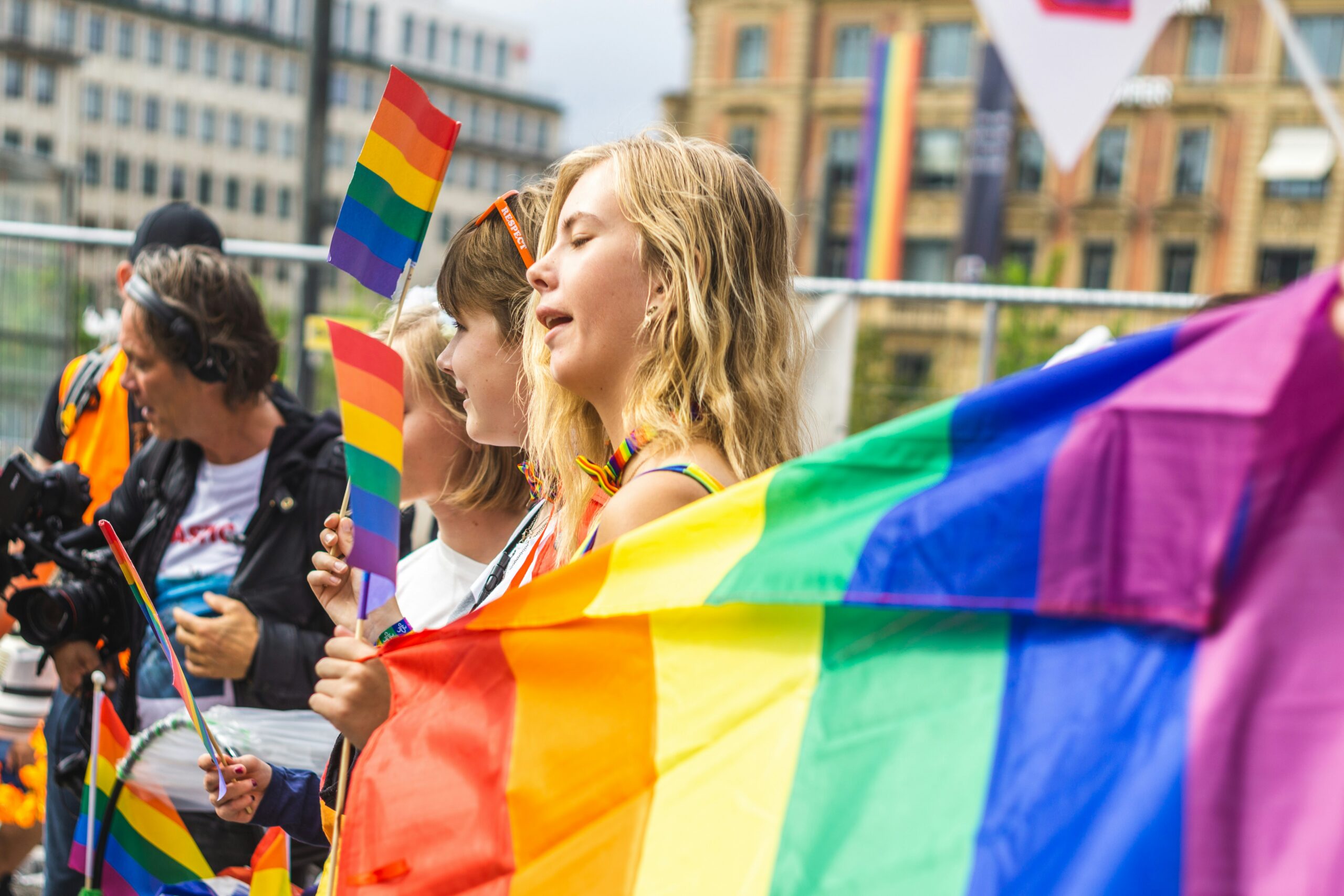 People holding a rainbow flag during Pride London.