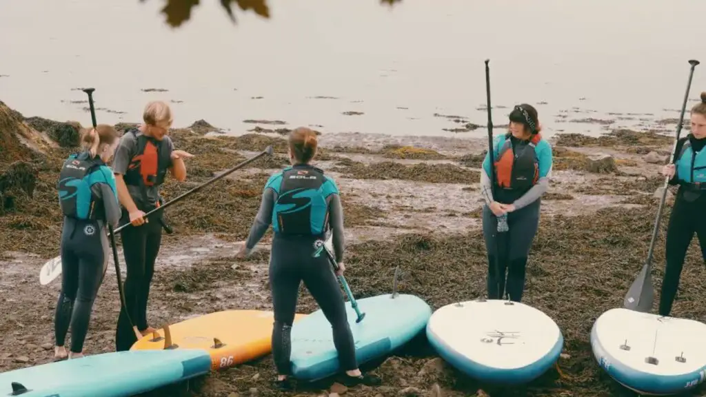 Women with paddle boards in the Out&Wild women festival in Wales.