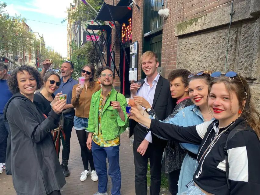A group of people holding drinks in Amsterdam.