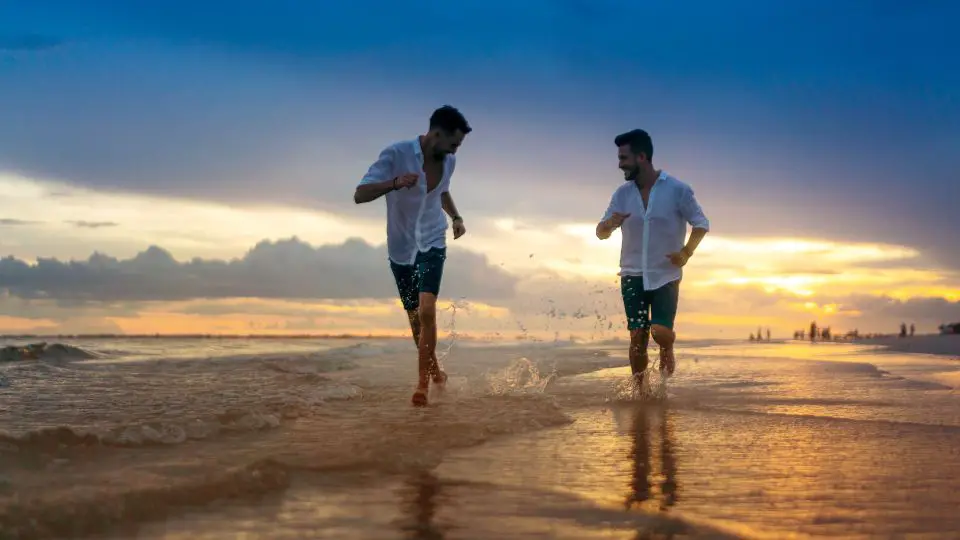 Two Guys running by the beach.